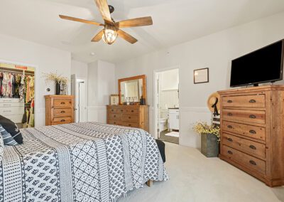 Bedroom with ceiling fan and open closet