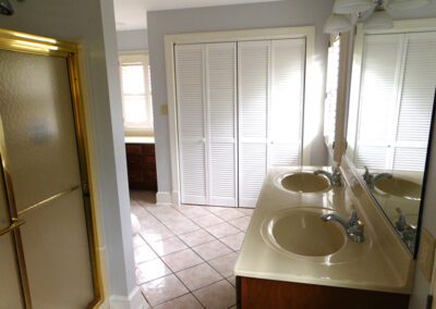 Bathroom with double sink, shower and closet